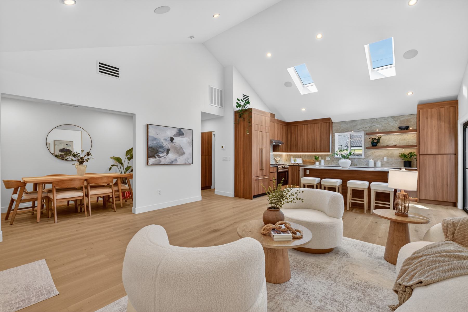 Open living, dining, and kitchen with vaulted ceiling